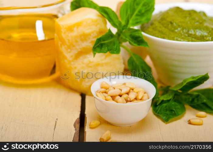 Italian traditional basil pesto sauce ingredients on a rustic table