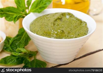 Italian traditional basil pesto sauce ingredients on a rustic table