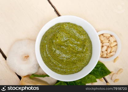 Italian traditional basil pesto sauce ingredients on a rustic table