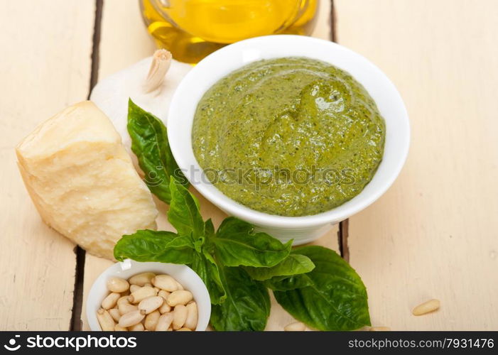 Italian traditional basil pesto sauce ingredients on a rustic table