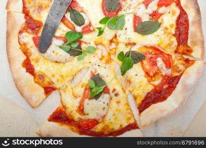 Italian traditional pizza Margherita tomato mozzarella and basil