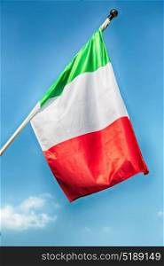 italian waving flag in the free sky concept of national symbol