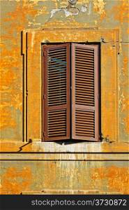 Italian Window with Closed Wooden Shutters in the Rome