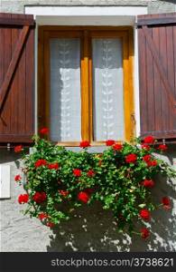 Italian Window with Open Wooden Shutters, Decorated With Fresh Flowers