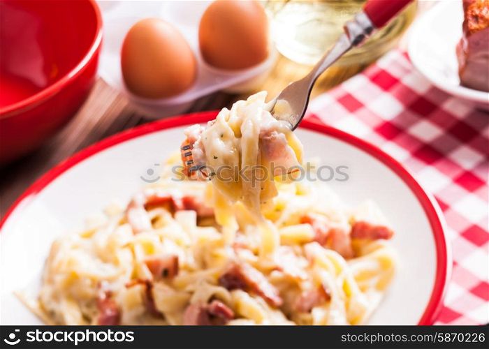 Italiatn traditional cuisine - pasta tagliatelle carbonara on a plate