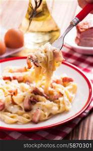 Italiatn traditional cuisine - pasta tagliatelle carbonara on a plate