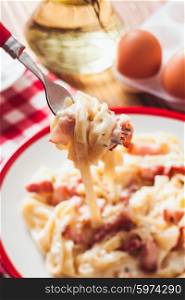 Italiatn traditional cuisine - pasta tagliatelle carbonara on a plate. Pasta tagliatelle carbonara