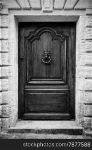 Italy. Ancient knocker on old wood door.