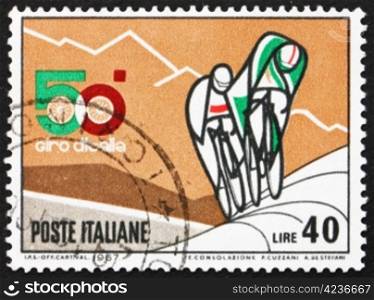 ITALY - CIRCA 1967: a stamp printed in the Italy shows Bicyclists and Mountains, 50th Bicycle Tour of Italy, The Giro, circa 1967