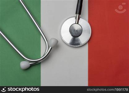 Italy flag and stethoscope. The concept of medicine. Stethoscope on the flag in the background.. Italy flag and stethoscope. The concept of medicine.