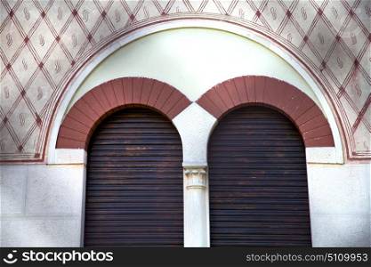 italy lombardy in the abbiate old church closed brick tower wall rose window tile shutter