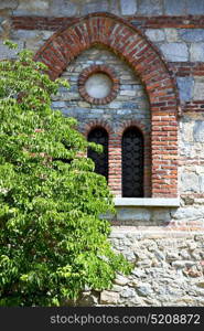 italy lombardy in the barza old church closed brick tower wall rose window tile abstract