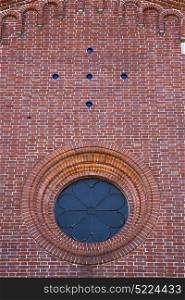 italy lombardy in the sumirago old church closed brick tower wall rose window tile