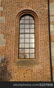 italy lombardy in the turbigo old church closed brick tower wall rose window tile