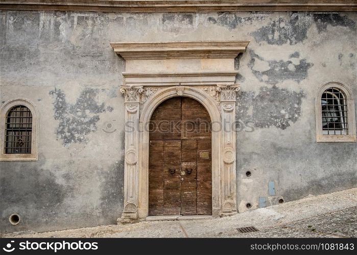 Italy: Old door on medieval stone wall