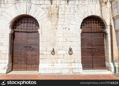 Italy: Old door on medieval stone wall