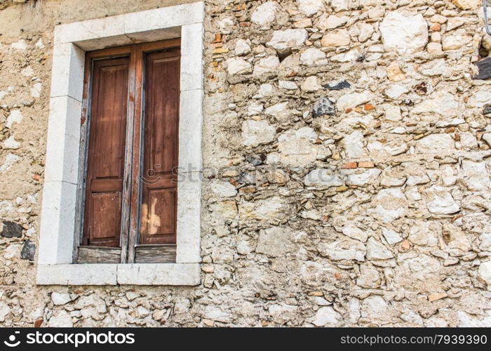 Italy: old window and rocky wall