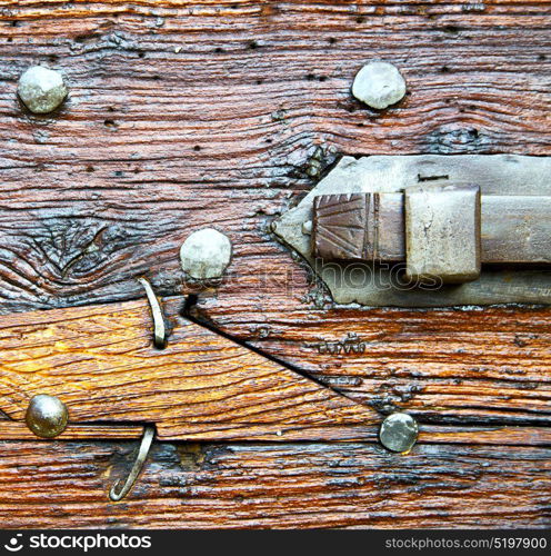 italy patch lombardy cross castellanza blur abstract rusty brass brown knocker in a door curch closed wood