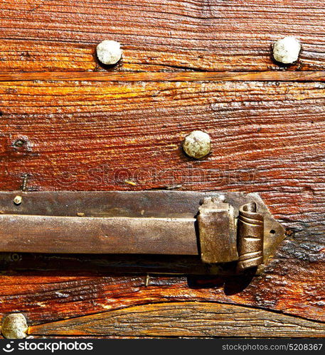 italy patch lombardy cross castellanza blur abstract rusty brass brown knocker in a door curch closed wood