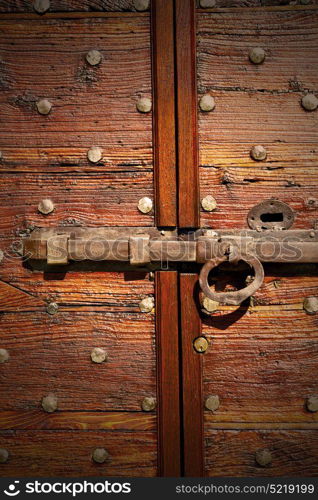 italy patch lombardy cross castellanza blur abstract rusty brass brown knocker in a door curch closed wood