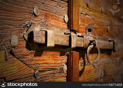 italy patch lombardy cross castellanza blur abstract rusty brass brown knocker in a door curch closed wood&#xA;