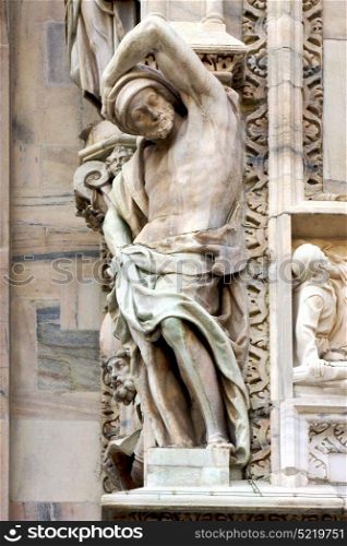 italy statue of a men in the front of the duomo church in milan and incision