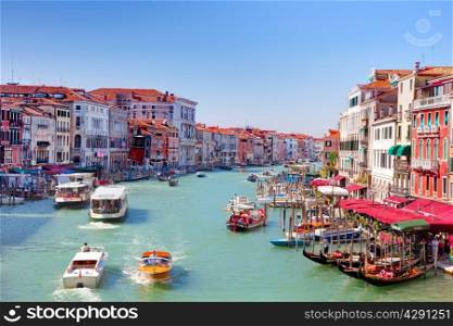 ITALY, VENICE - AUGUST 25 - Gondolas and tourist boats traffic on the Grand Canal on August 25, 2014 in Venice, Italy. The entire city with its lagoon is listed on the World Heritage Site