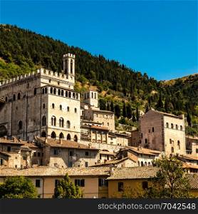 Italy: view of the ducal palace of Gubbio. In the background the wooded forest of Mount Ingino