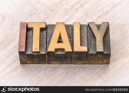 Italy word in vintage letterpress wood type against grained wood