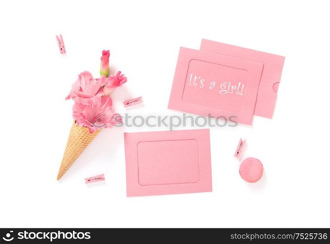 Its a Girl. Pink cards and flowers on white background. Birthday. Baby shower flat lay