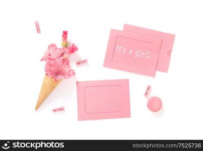 Its a Girl. Pink cards and flowers on white background. Birthday. Baby shower flat lay