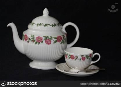 Ivory teapot and teacup with floral design