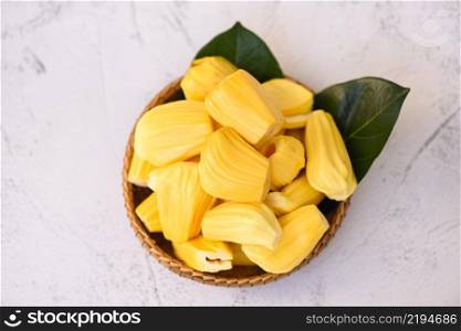 jackfruit on wooden basket with leaf, ripe jackfruit peeled tropical fruit fresh from jackfruit tree