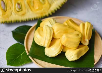 jackfruit on wooden plate with leaf, ripe jackfruit peeled tropical fruit fresh from jackfruit tree