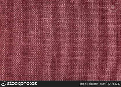 Jacquard woven upholstery, red coarse fabric texture. Textile background, furniture textile material, wallpaper, backdrop. Cloth structure close up.