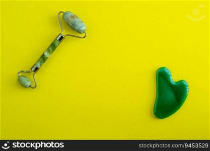 Jade massagers on a yellow background. Background with copy space. Background for advertising. 