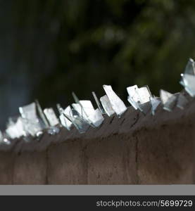 Jagged pieces of glass on the top of a wall in Thimphu, Bhutan