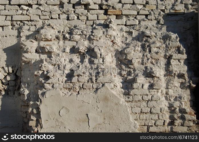 Jagged white painted brick wall as background