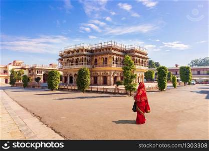 Jaipur City Palace and Indian girl in sari, India.