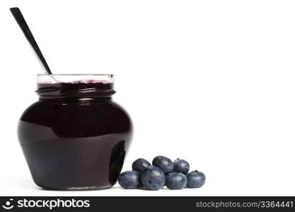 jam jar with blueberry jam a spoon and blueberries aside. jam jar with blueberry jam a spoon and blueberries aside on white background