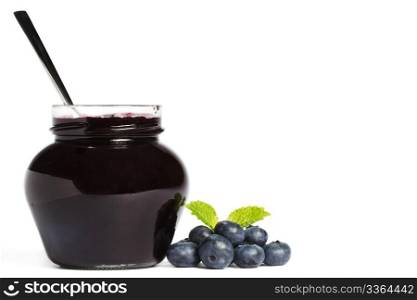 jam jar with blueberry jam a spoon and blueberries with a leaf melissa. jam jar with blueberry jam a spoon and blueberries with a leaf melissa aside on white background