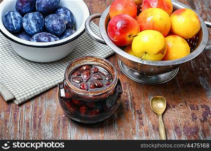Jam with plums. Glass jar with jam from the harvest of autumn plums