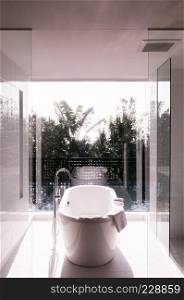 JAN 30, 2018 Miyako, Okinawa - Japan : Open air warm cozy modern style bathroom with bathtub with natural light and view