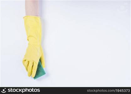 janitor s hand with yellow gloves holding sponge white background. High resolution photo. janitor s hand with yellow gloves holding sponge white background. High quality photo