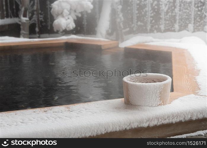 Japan natural mineral hot spring called onsen cover by snow in Japanese ryokan on the moutain okuhida takayama japan.