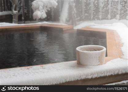Japan natural mineral hot spring called onsen cover by snow in Japanese ryokan on the moutain okuhida takayama japan.