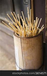 Japan, Takayama, Skewers for Japanese dumplings (Dango) in wooden bucket