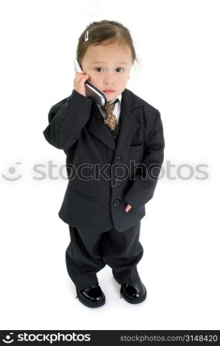 Japanese American 2 year old girl in suit with cellphone.