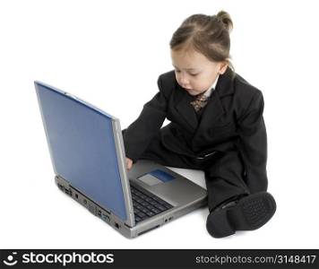 Japanese American girl sitting on floor with laptop. Wearing suit.