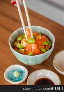 Japanese assorted raw seafood rice bowl sashimi Don buri with salmon egg roe, tobiko and green peas.